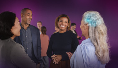 A diverse group of people smiling while talking